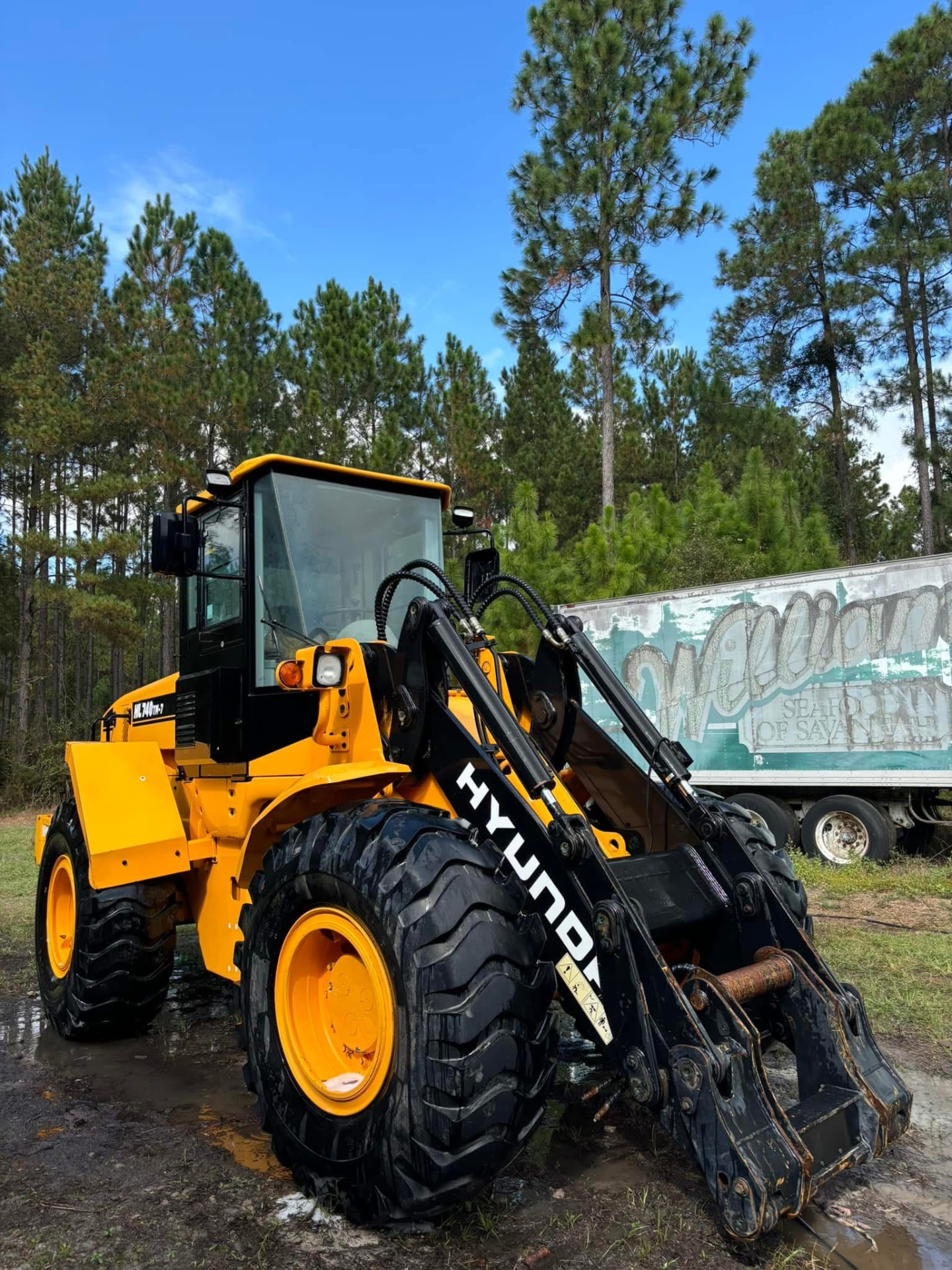 Same wheel loader cleaned and gleaming after pressure washing