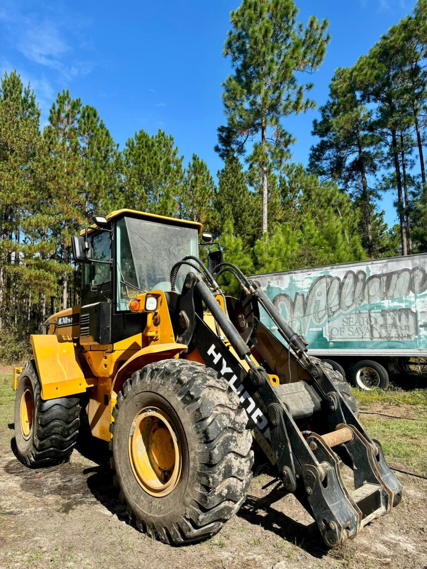 Muddy Hyundai wheel loader before pressure washing